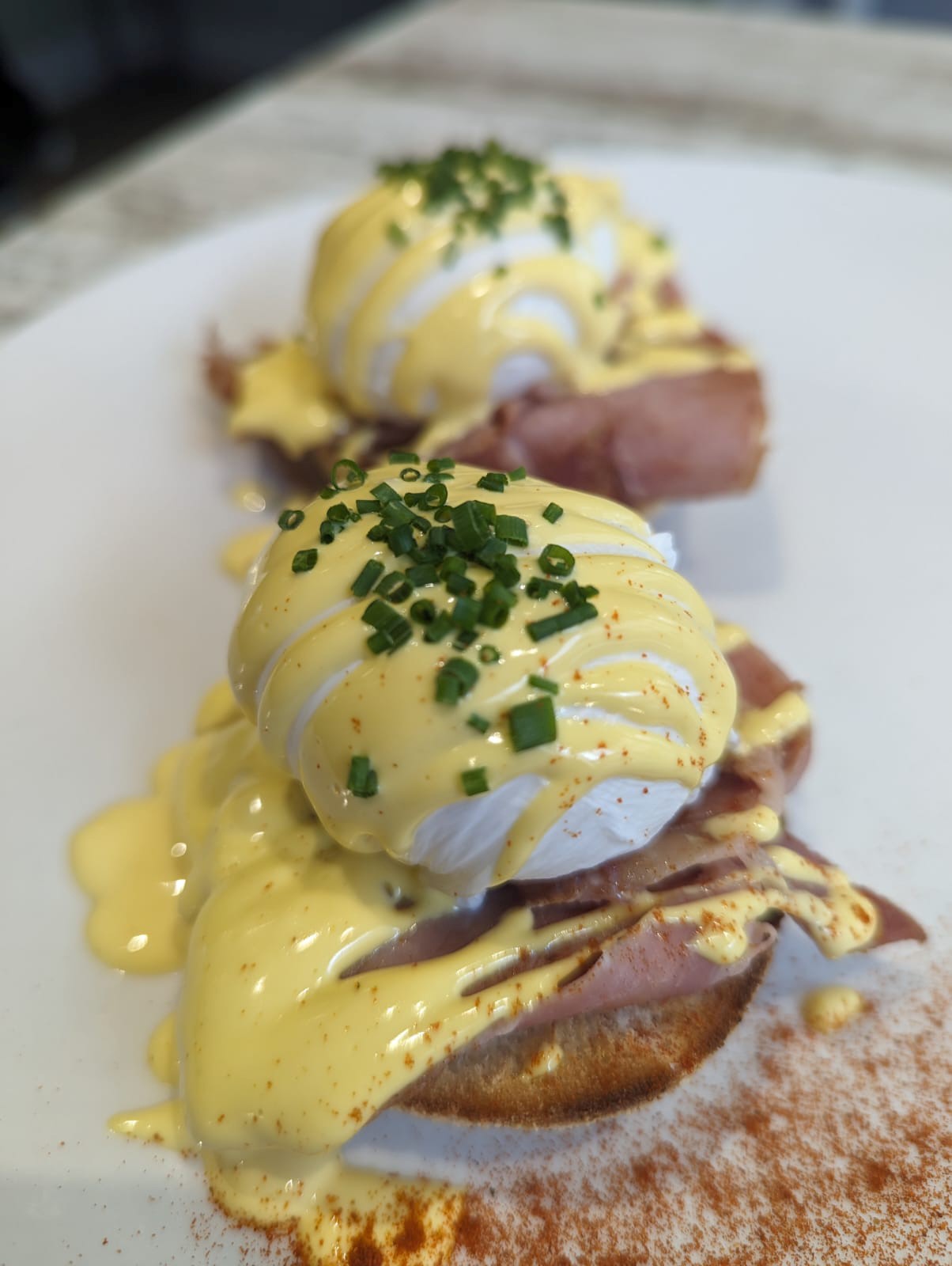 Perfectly poached eggs with hollandaise sauce - signature breakfast dish